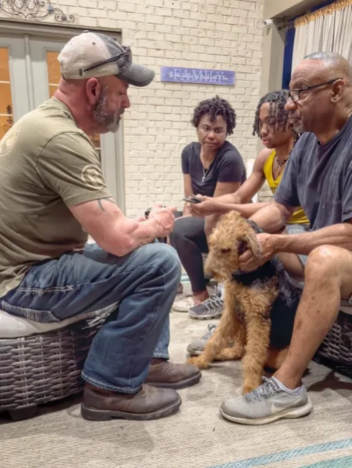A trainer working with a family and their goldendoodle on the porch