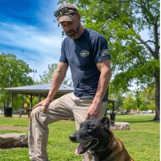Jeff Aman working with a dog in the park